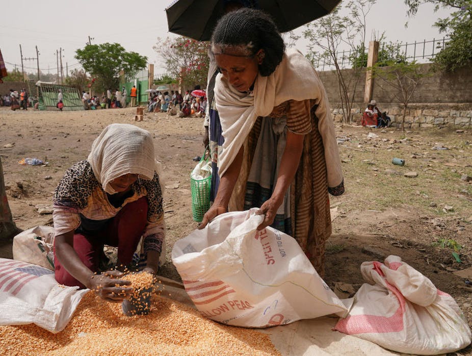 Woman receiving a portion of lentils