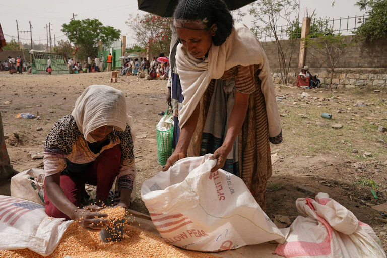 Woman receiving a portion of lentils
