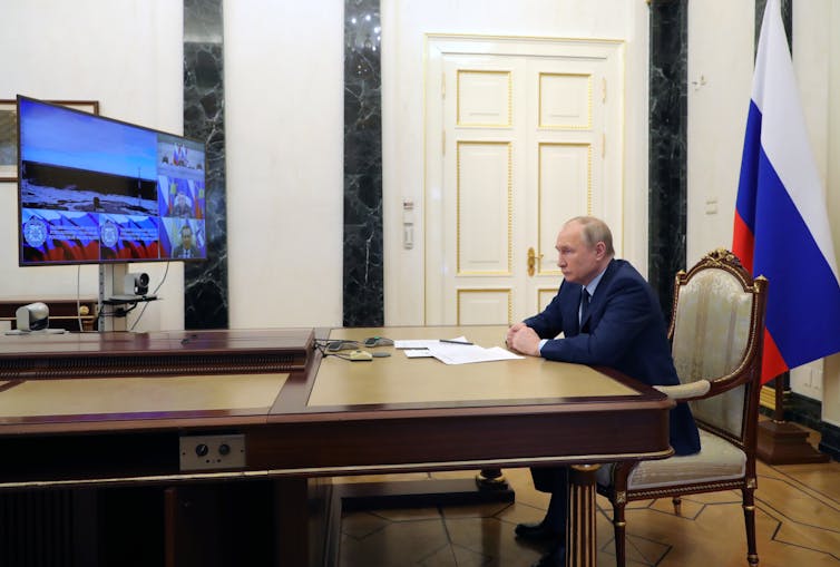 Vladimir Putin watches the launch of Russia's Sarmat ICBM via video link in his office in the Kremlin, April 2022.