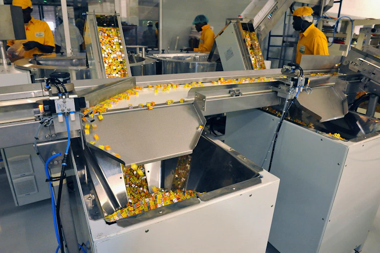Men wearing yellow in a factory