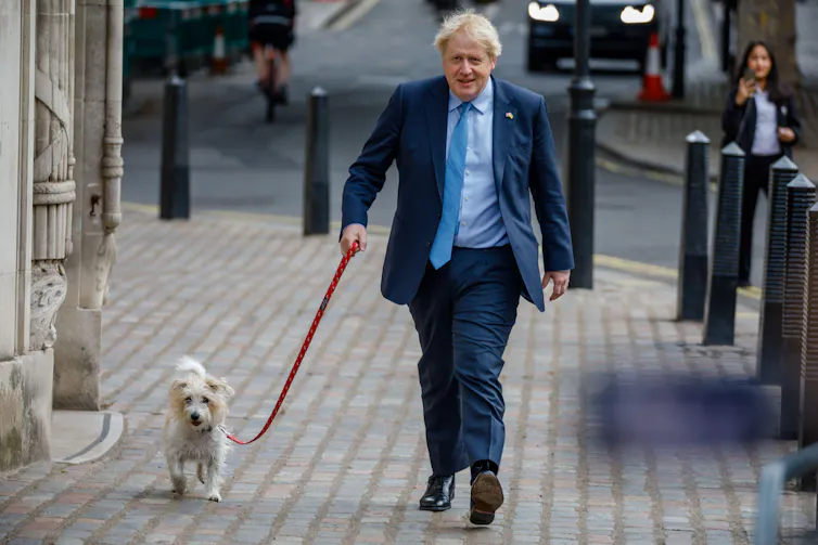 Boris Johnson walking to his polling station in London with his dog.