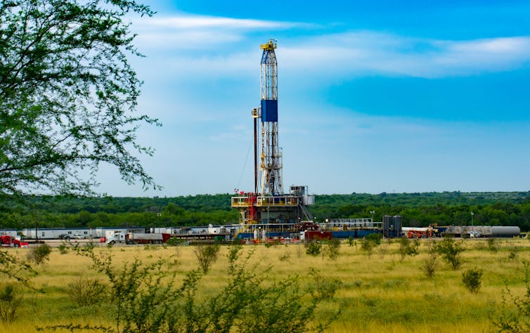 A metal column in a green field.