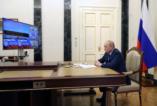 "Vladimir Putin watches the launch of Russia's Sarmat ICBM via video link in his office in the Kremlin, April 2022.