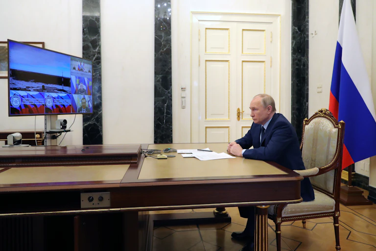 "Vladimir Putin watches the launch of Russia's Sarmat ICBM via video link in his office in the Kremlin, April 2022.