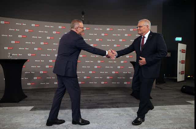 two men shake hands