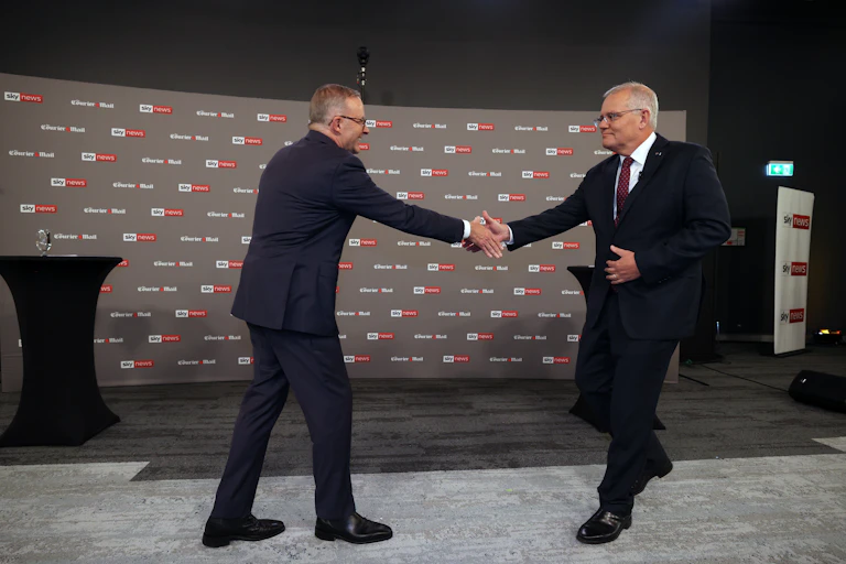 two men shake hands