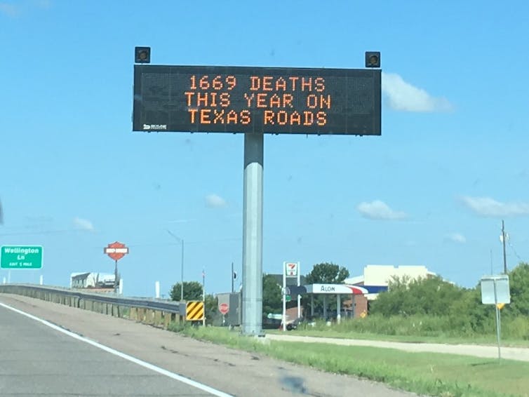 a road sign saying 1669 DEATHS THIS YEAR ON TEXAS ROADS
