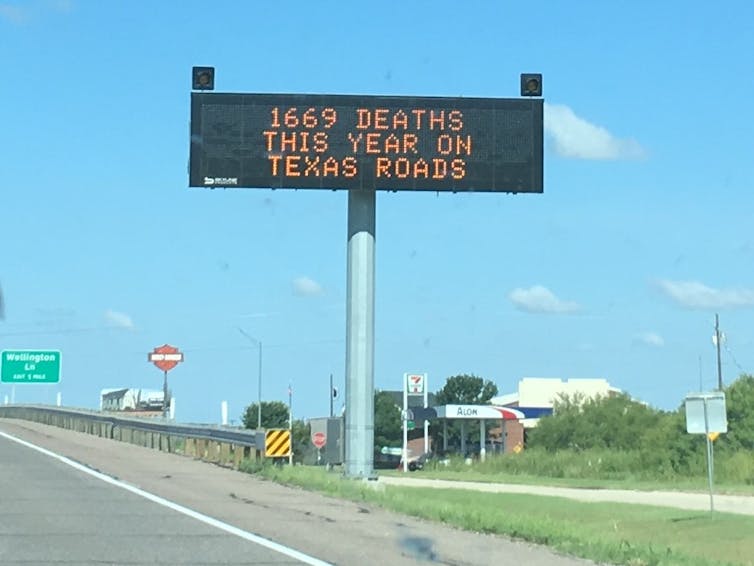 a road sign saying 1669 DEATHS THIS YEAR ON TEXAS ROADS