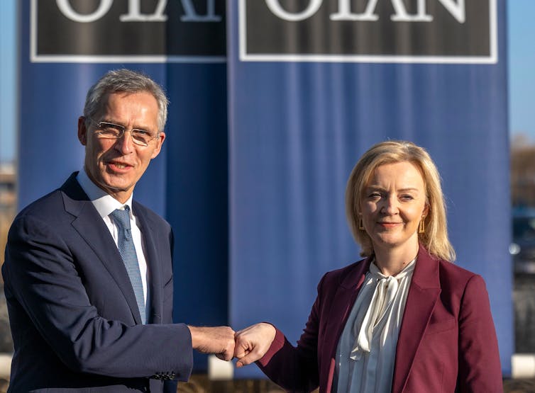 Liz Truss fist bumps Nato secretary general Jens Stoltenberg