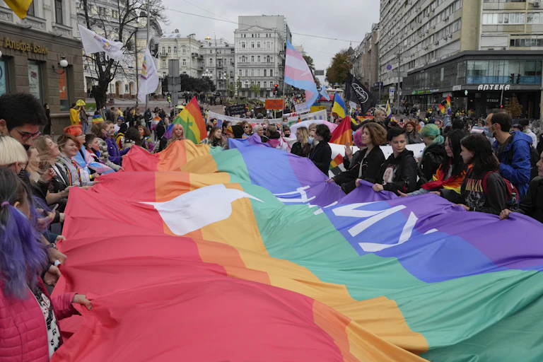 People hold a massive pride flag