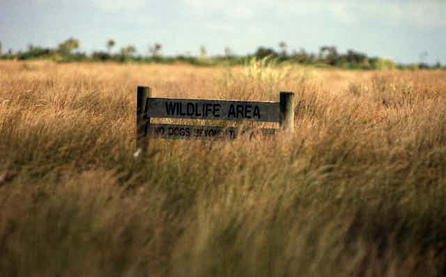 'Wildlife area' sign in grassland