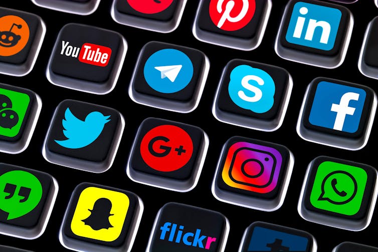 Social media platform logos displayed on a keyboard