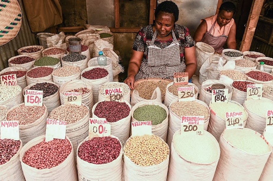 Women looking into bags of grains