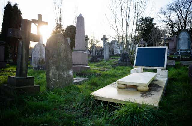 An unmarked grave with a headstone that resembles a computer screen, nicknamed 'iGrave', is seen in north-west London.