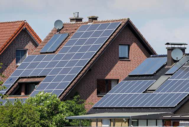 Homes with slanted roofs covered with solar panels