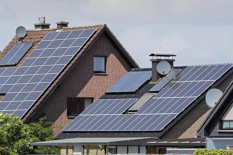 Homes with slanted roofs covered with solar panels