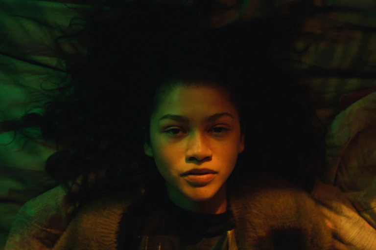 Zendaya laying on the bed