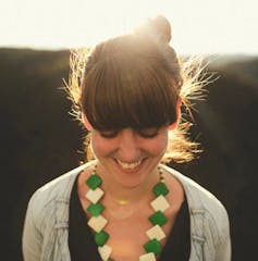 woman smiling, looking down