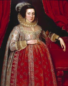 Portrait of a heavily pregnant woman in period dress.