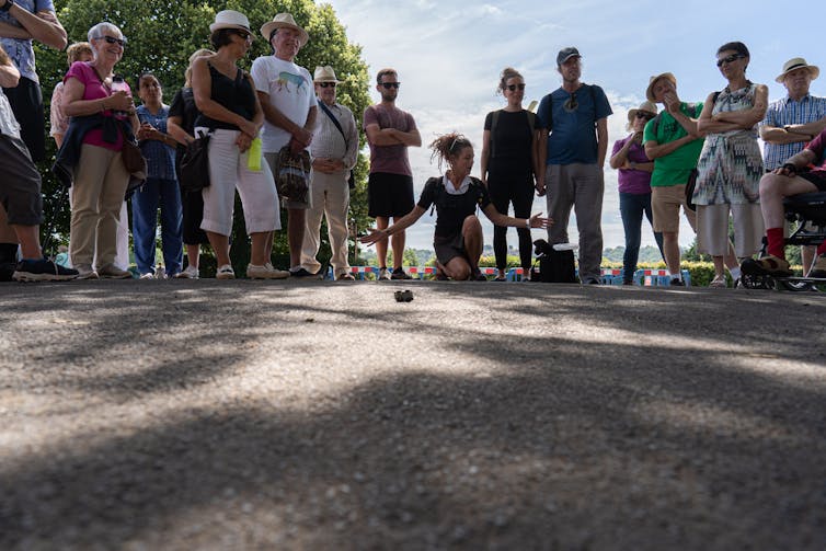 A group of walkers take part in an outdoor performance.