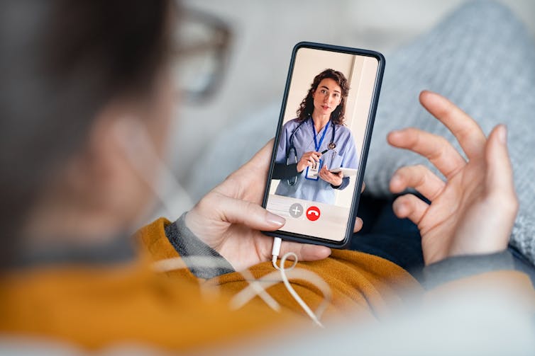 Woman talks to doctor via a smartphone