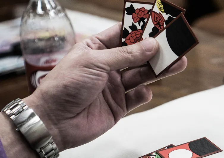 Man plays cards.