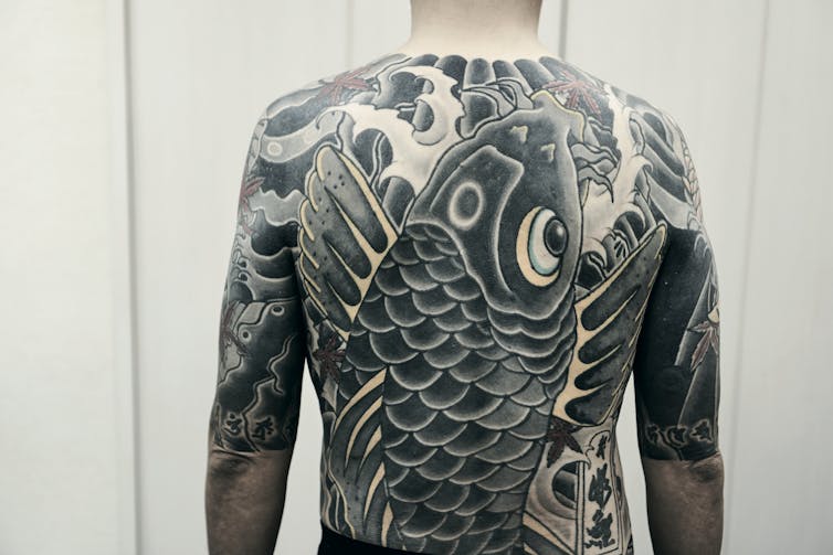 Large back tattoo.