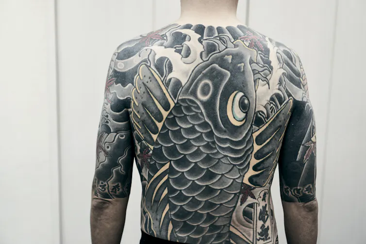 Large back tattoo.