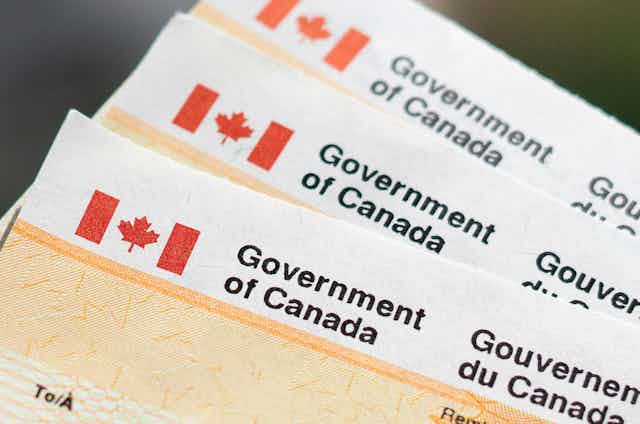 A close-up stack of cheques from the Government of Canada