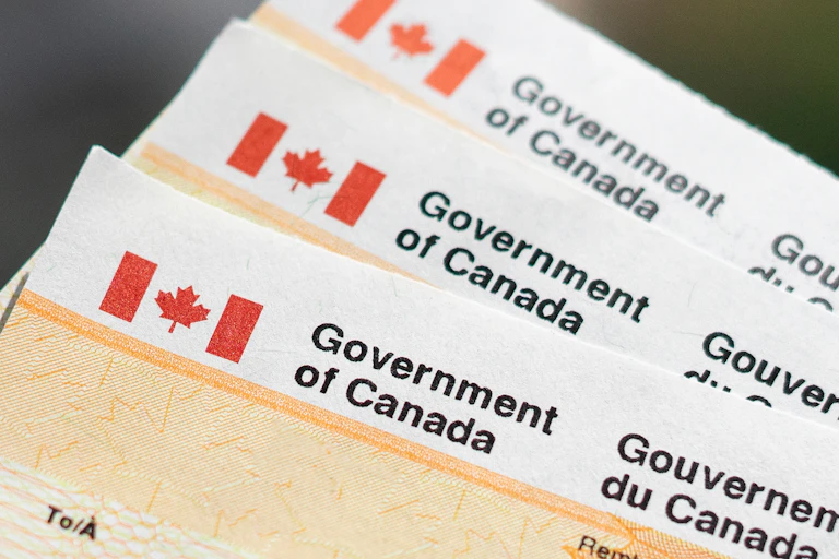 A close-up stack of cheques from the Government of Canada