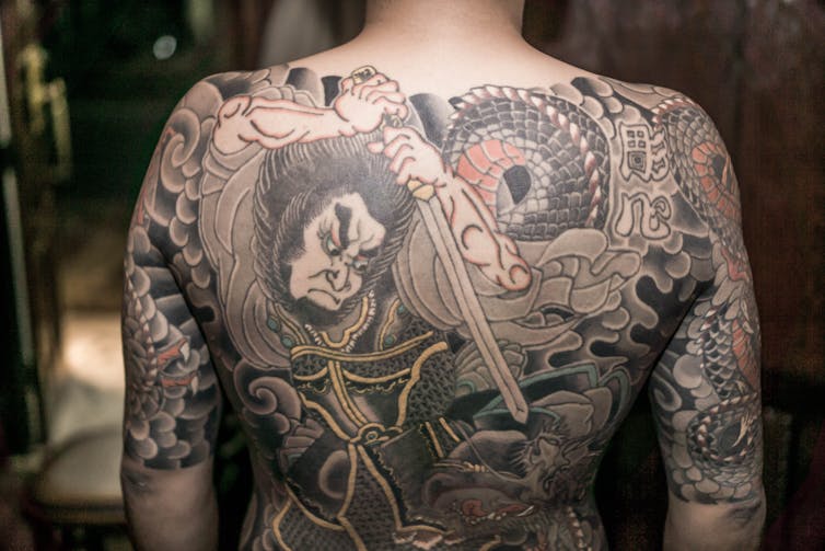 Large back tattoo.