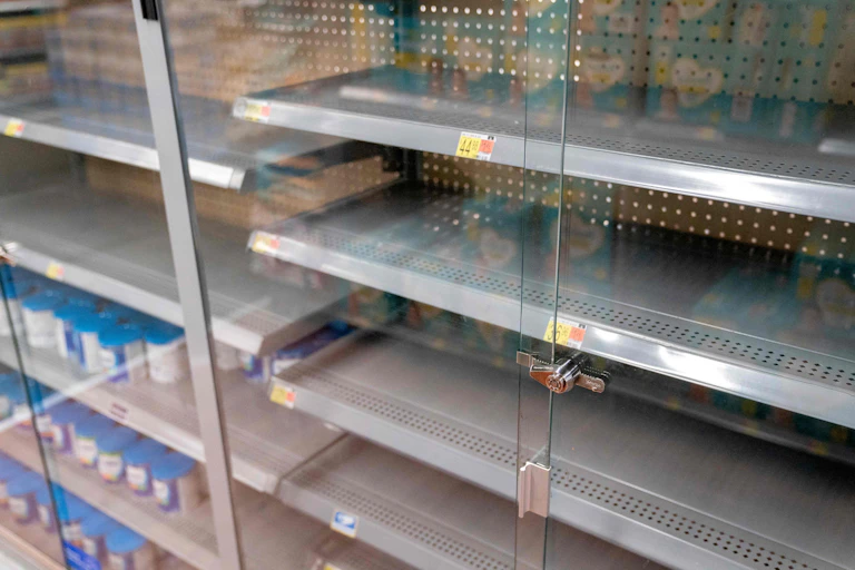 Rows of empty shelves at a grocery store.