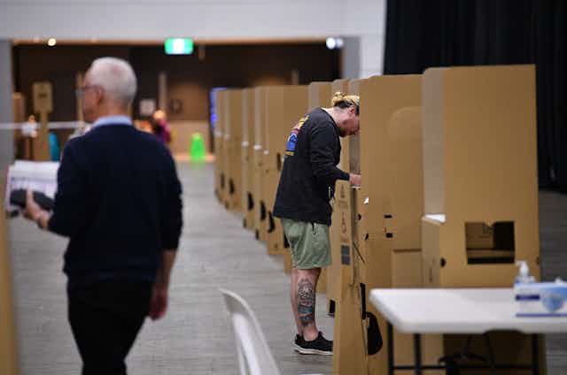 A man casting his vote at an Australian federal election pre-polling booth. 