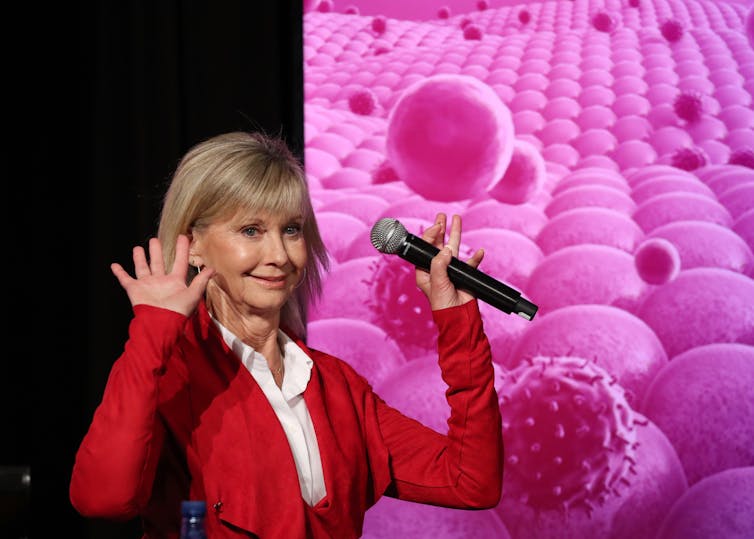 Olivia Newton-John addresses the Victorian Comprehensive Cancer Center research conference in Melbourne in September 2019.