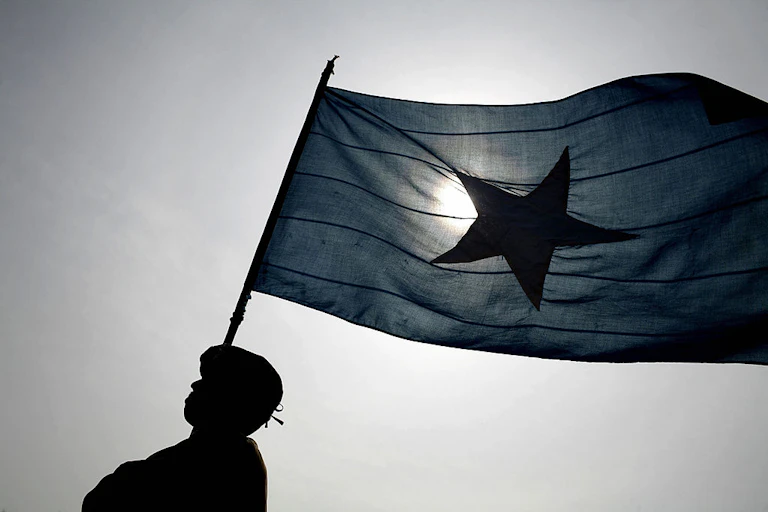 A man in police uniform holding a flag