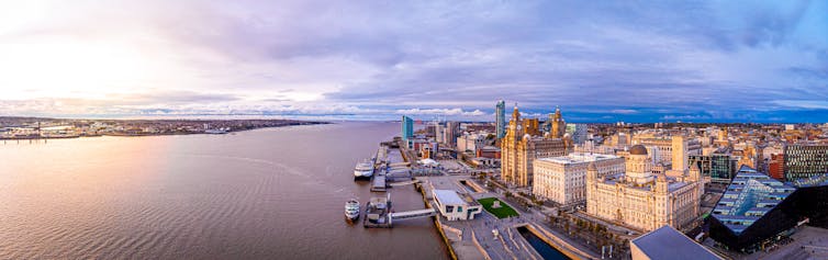 Overhead view of Liverpool cityscape and waterfront at dusk.
