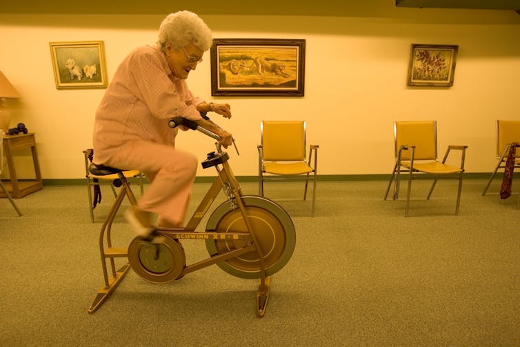 Old lady on exercise bike