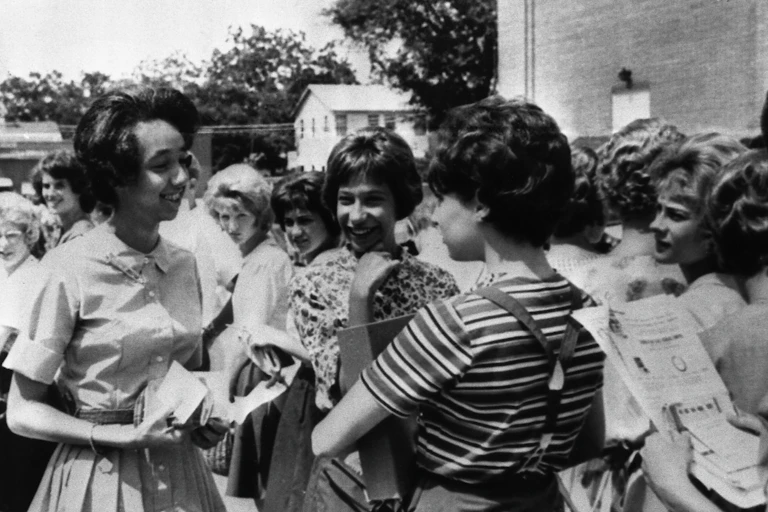 A young Black woman stands with a group of other students