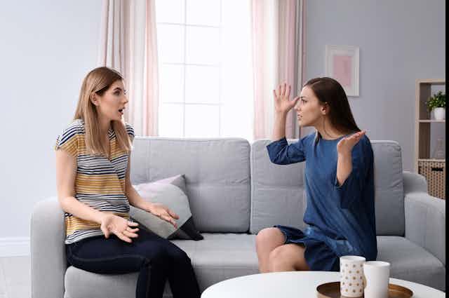 two women on a sofa arguing