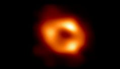An image showing a donut-shaped cloud of reddish-orange gas.