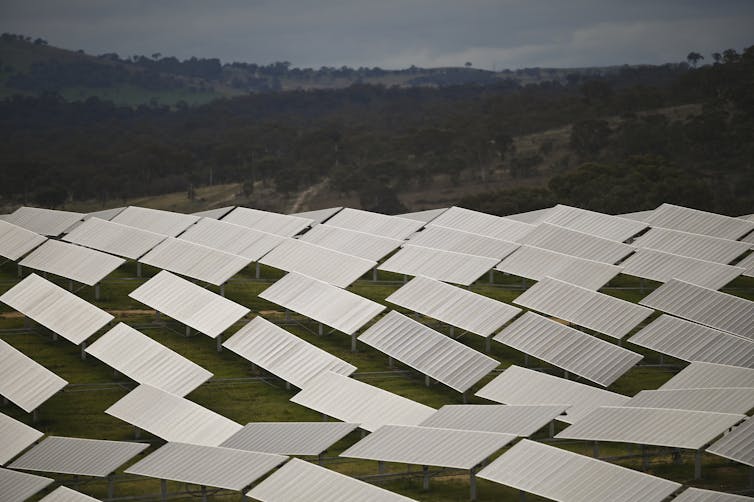 rows of solar panels with hills