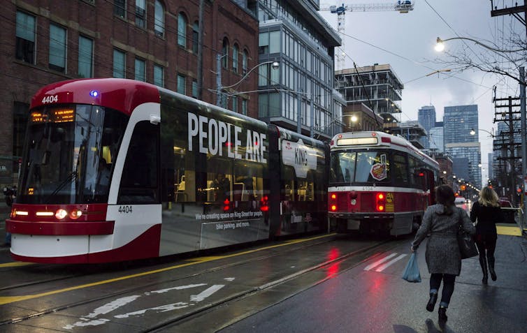 streetcars heading in opposite directions on a city street