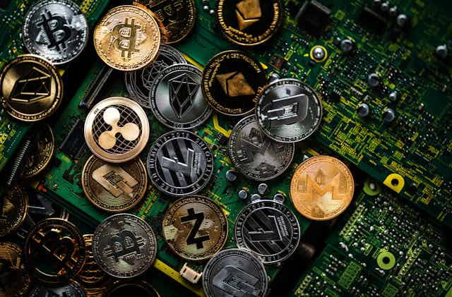 Various crypto coins on a circuit board.
