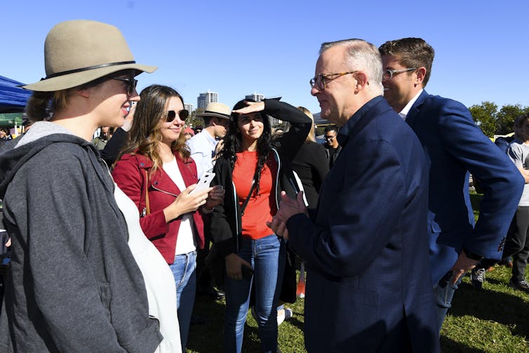 Albanese chats to the crowd at a market