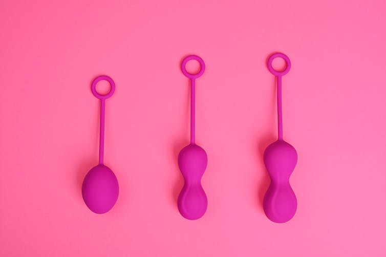 bright pink shapes with long handles
