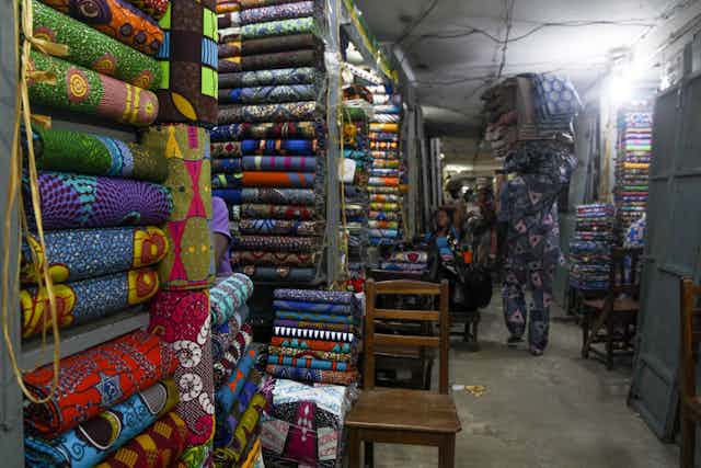 A man carries fabric pieces into his shop at the Seme-Podji market, the border town between Benin and Nigeria.