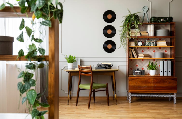 A mid-century modern room with desk and bookcase.