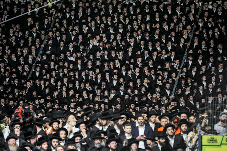 Hundreds of Jewish men gathered for a pilgrimage wearing traditional dress.