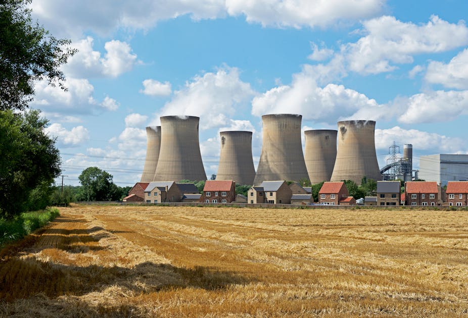 Power station on a sunny day next to a farm