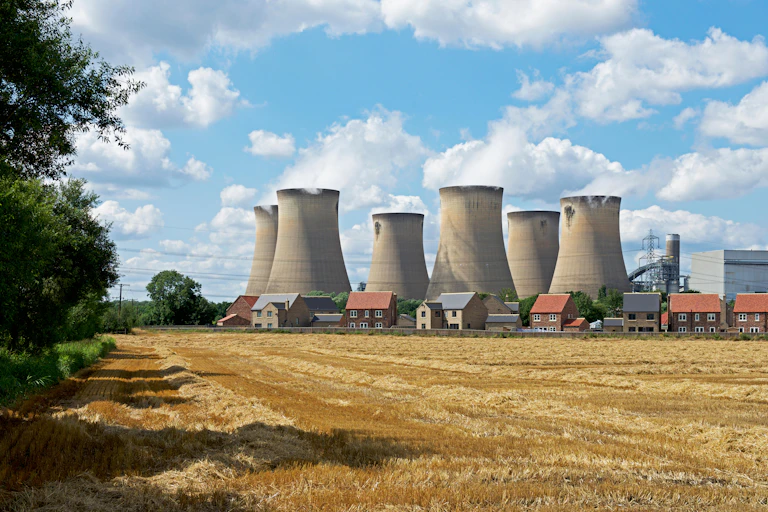 Power station on a sunny day next to a farm
